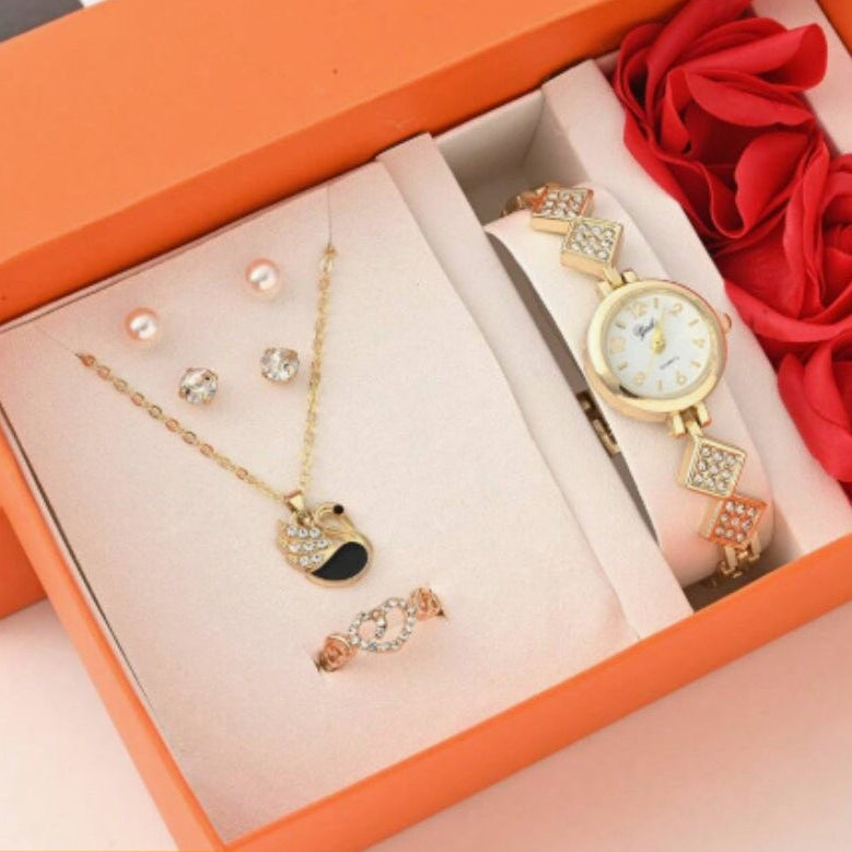 Jewelry set with a watch and necklaces in an open box with red flowers.